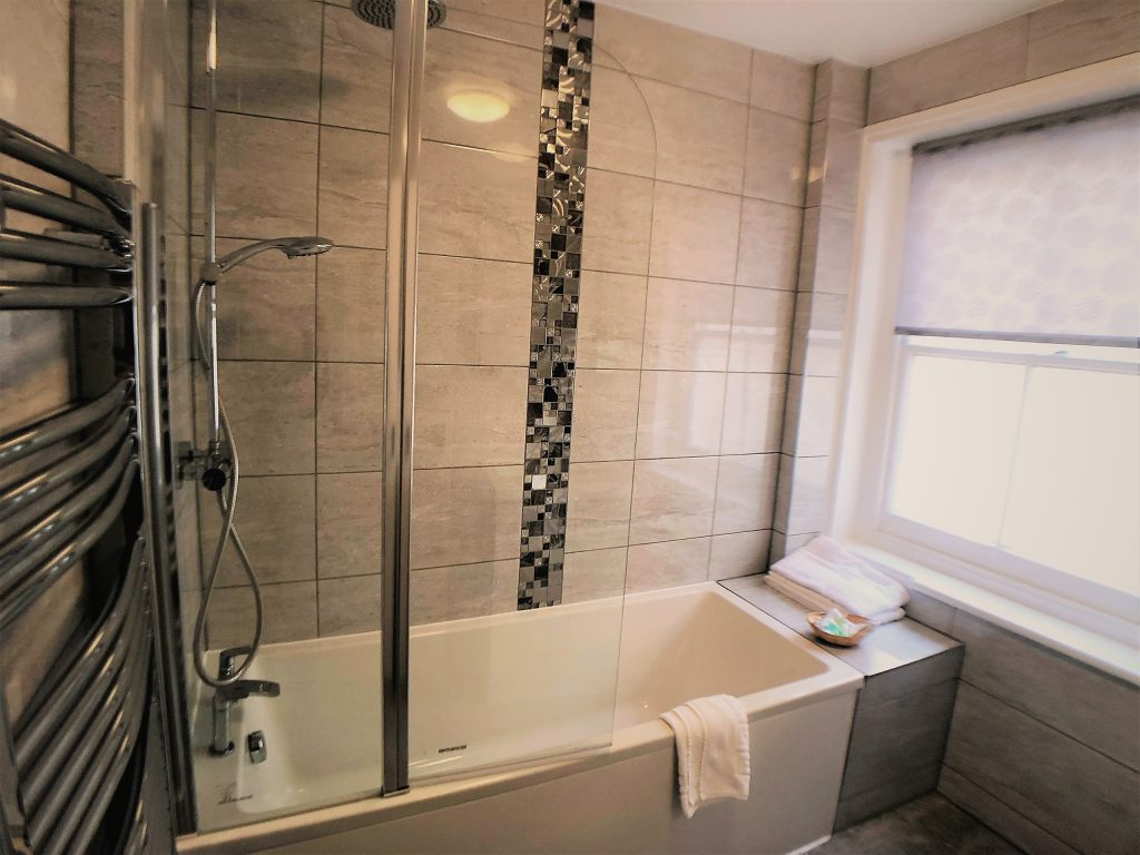 Bathroom with bath and shower
