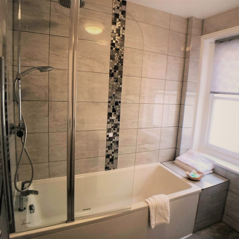 Bathroom with bath and shower