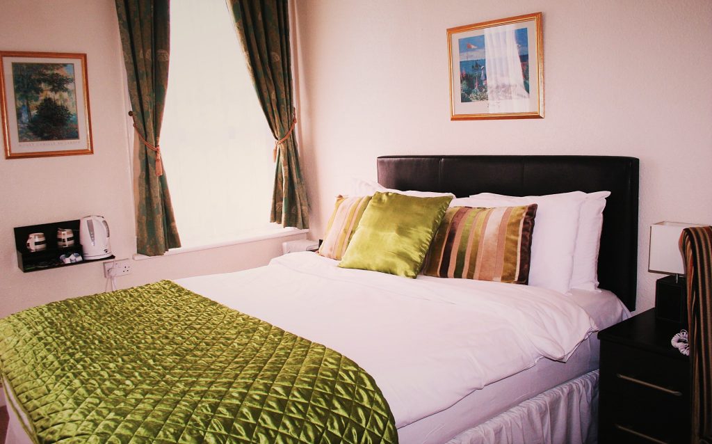 Bright double room with seaside artwork