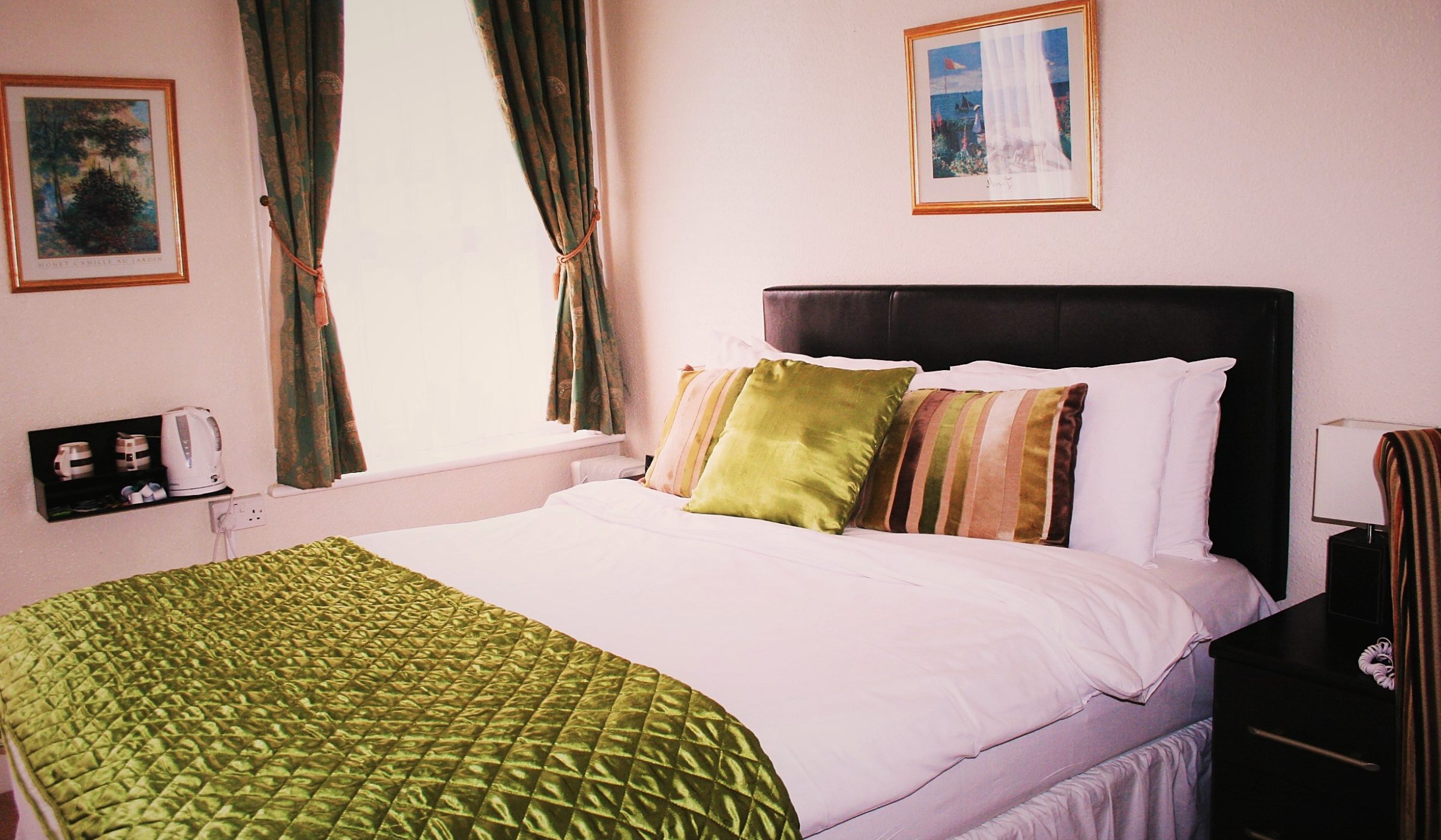 Bright double room with seaside artwork