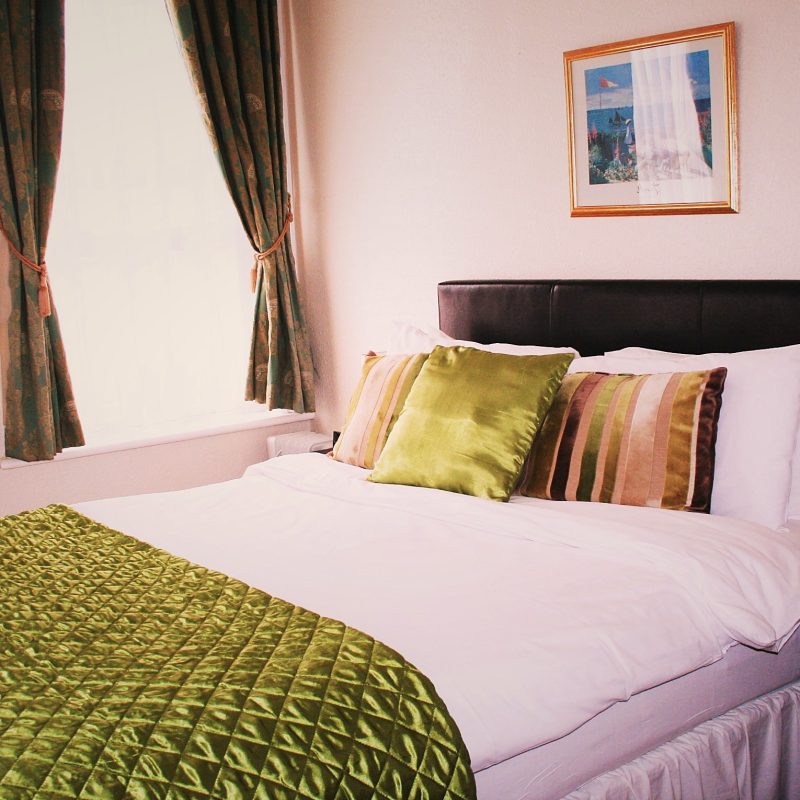 Bright double room with seaside artwork